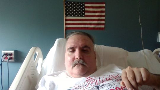 Me in front of the American flag. A couple weeks ago. I shaved off the mustache, so I look a little different now. So let me know what you think.