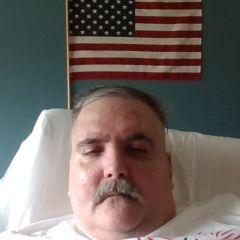 Me in front of the American flag. A couple weeks ago. I shaved off the mustache, so I look a little different now. So let me know what you think.